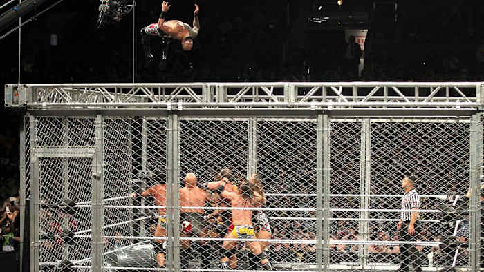 Ricochet performs a moonsault from the top of the cage at "NXT TakeOver: WarGames" in 2018.
